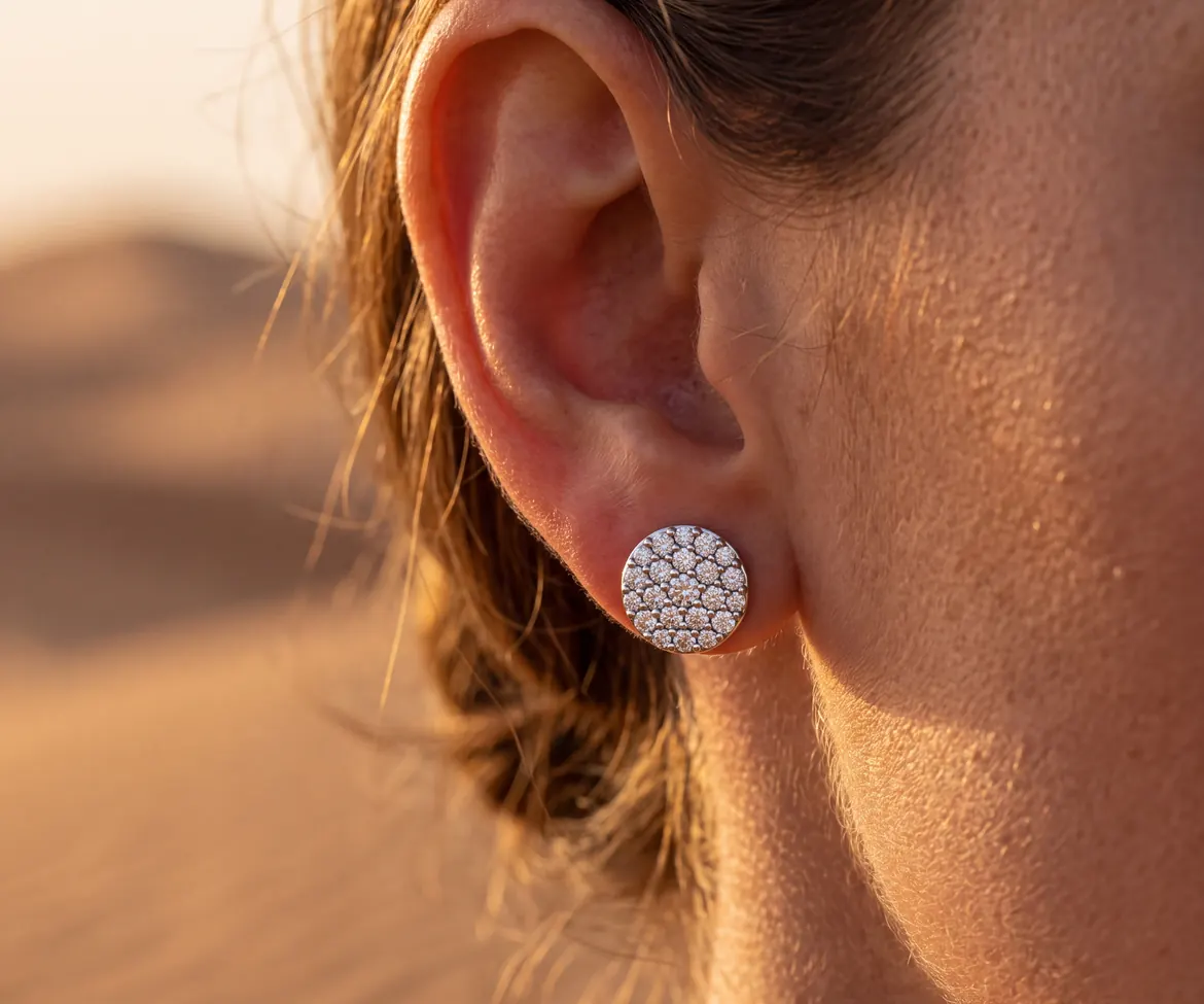 Pave diamond cluster stud earring worn on the ear in warm desert light